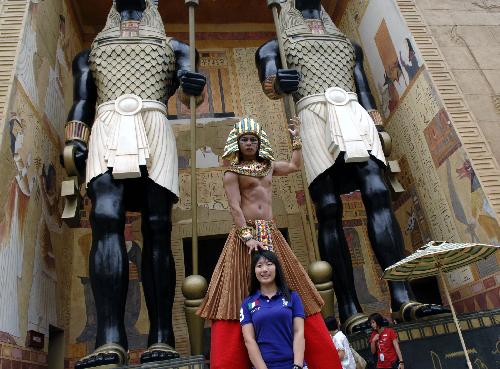 A visitor poses for photos in the Universal Studios theme park on the Sentosa Island in Singapore, March 16, 2010. 