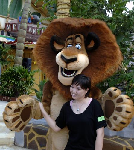 A visitor poses for photos at the Universal Studios theme park on the Sentosa Island in Singapore, March 16, 2010. 