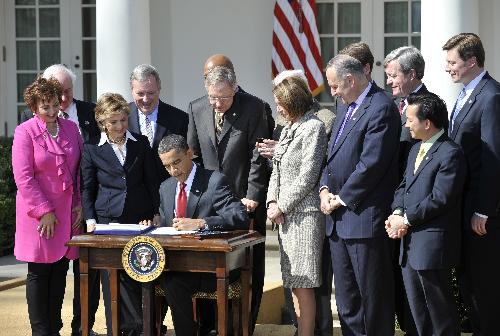 U.S. President Barack Obama signs the Hire act in the rose garden at the White House in Washington D.C., capital of the United States, March 18, 2010. Barack Obama on Thursday signed into law the Hire Act, a bill that will spur job growth and strengthen the private sector by encouraging businesses to hire new workers and invest in their companies and communities. The legislation includes about 18 billion dollars in tax breaks and 20 billion dollars into highway and transit programs. [Zhang Jun/Xinhua]