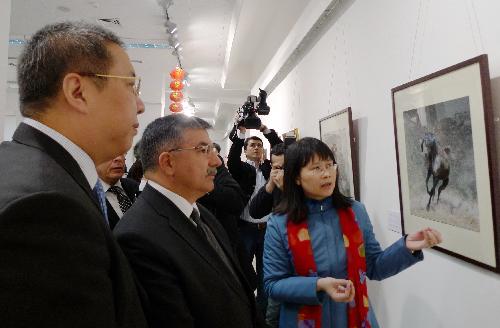 Ismet Yilmaz (2nd L), undersecretary of Turkish Culture and Tourism Ministry, and Gong Xiaosheng (1st L), Chinese ambassador to Turkey, visit an exhibition on China's Suzhou embroidery, in Ankara, capital of Turkey, March 18, 2010. Some 60 pieces of Suzhou embroidery works were on show during the exhibition. [Wang Xiuqiong/Xinhua]