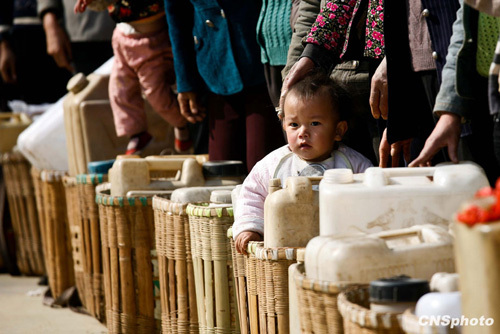 People are lining up for drinking water in Xiaoyangchang Village, Fuyuan County of Yunnan Province, on March 12, 2010. Parts of southern China are being ravaged by a severe three-season drought. More than 20 million of people lack adequate water supplies, and millions of acres of cropland are too dry to plant.