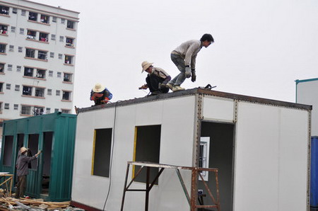 Workers revamp and paint a new container house near the 107 National Highway, Xinwu Street, Shenzhen Bao'an District.[