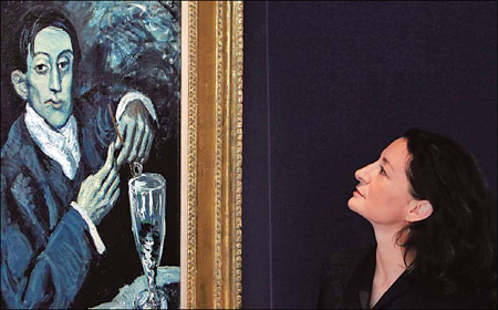 Giovanna Bertazzoni, Christie's auction house head of Impressionist and Modern Art department, examines the 1903 Pablo Picasso painting entitled Portrait of Angel Fernandez de Soto (The Absinthe Drinker) this week.