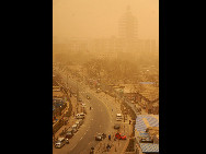 Buildings are covered in sands under sand-dust weather in Beijing, capital of China, March 22, 2010. The Central Meteorological Station issued a blue alert for sandstorms at 6 AM on Monday. [Xinhua] 