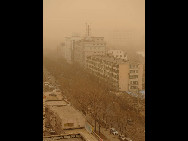 Permeating yellow sands suffuse over Beijing, March 22, 2010. A sand-dust weather pervades Beijing once again, as the Central Meteorologic Station issued blue alert signal for sandstorm attack on 6 am. [Xinhua]