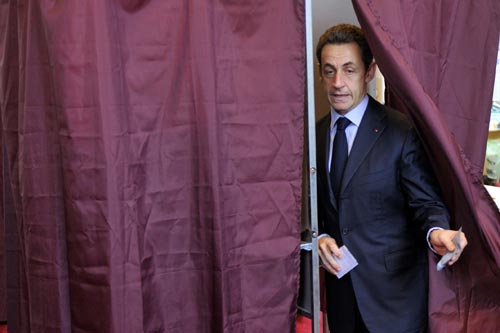 France's President Nicolas Sarkozy leaves the polling booth before casting his ballot at a Paris polling station in the second round of regional elections March 21, 2010. Sarkozy's centre-right UMP party is due to face heavy losses in regional elections on Sunday that could affect the pace of reform as manoeuvring begins before the 2012 presidential campaign.[Xinhua] 