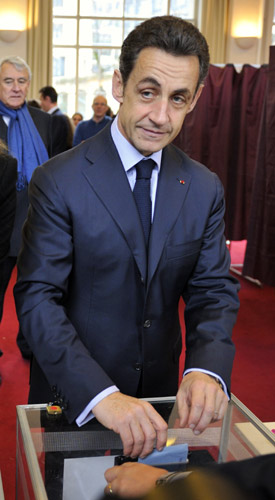 France's President Nicolas Sarkozy casts his ballot at a Paris polling station in the second round of regional elections March 21, 2010. Sarkozy's centre-right UMP party is due to face heavy losses in regional elections on Sunday that could affect the pace of reform as manoeuvring begins before the 2012 presidential campaign.[Xinhua] 