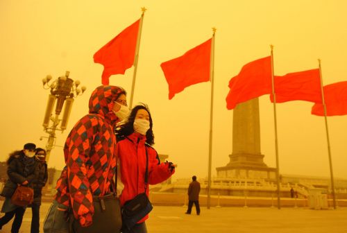 Tourists visit Tiananmen Square in Beijing, capital of China, March 20, 2010. A severe sandstorm that plagued northwestern China in the past few weeks arrived in Beijing Friday night, packing strong winds and tones of sand. [Xinhua]
