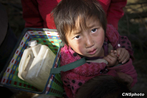 A child is lining up for drinking water in Xiaoyangchang Village, Fuyuan County of Yunnan Province, on March 12, 2010. Parts of southern China are being ravaged by a severe three-season drought. More than 20 million of people lack adequate water supplies, and millions of acres of cropland are too dry to plant.
