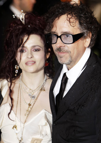 Director Tim Burton and his wife actress Helen Bonham Carter pose for photographers as they arrive for the Royal World Premiere of Alice In Wonderland at Leicester Square in London Feb. 25, 2010.