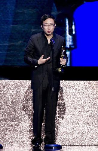 Director Lu Chuan addresses the awarding ceremony after winning the Best Director award at the Asian Film Awards in Hong Kong, south China, on March 22, 2010.