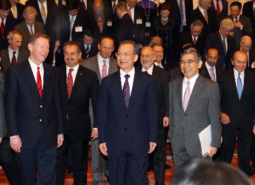 Chinese Premier Wen Jiabao (C) walks with foreign delegates attending the two-day China Development Forum 2010 before their meeting in Beijing, China, March 22, 2010. [Liu Weibing/Xinhua] 