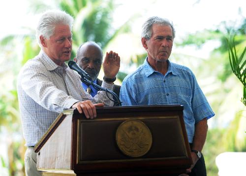 Former U.S. president Bill Clinton (L) speaks as Haiti's President Rene Preval and former U.S. president George W. Bush listen during a news conference at the destroyed national palace in Port-au-Prince March 22, 2010. Clinton and Bush are in Haiti to discuss the impoverished country's long-term recovery after a January earthquake killed hundreds of thousands of people. [Xinhua]