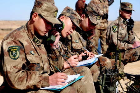 Soldiers allocate the coordinates before the blast on the ice of the dangerous Minjibu Reach of the Yellow River under the bombardment in Tumd Right Banner of north China's Inner Mongolia Autonomous Region on March 22, 2010. The 1.5-meter-high ice dam filling up in the riverway was scrapped to meet the extensive ice run.[Xinhua]