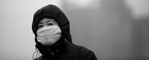 A pedestrian walks through a severe sandstorm that hits Beijing on Monday. 