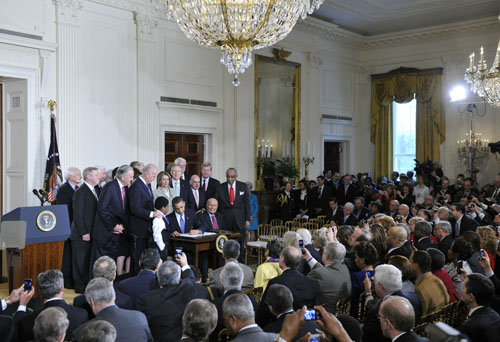 U.S. President Barack Obama signs the healthcare reform bill at the White House in Washington D.C., capital of the United States, March 23, 2010. [Zhang Jun/Xinhua] 