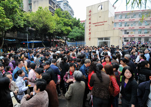Parents send their children to the Experimental School, where a knife attack occurred on Tuesday, in Nanping City, southeast China's Fujian Province, March 24, 2010.