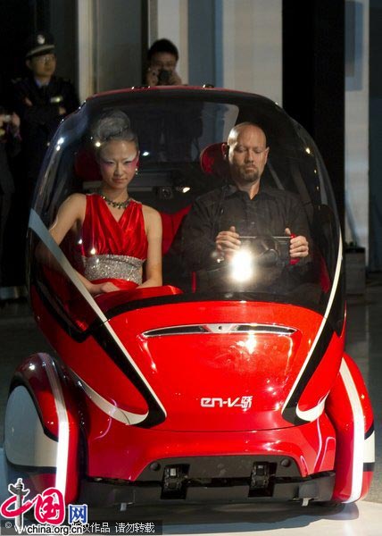 An EN-V, or &apos;Electric Networked-Vehicle&apos;, is driven by a General Motors&apos; staff member during an event to unveil its new concept car in Shanghai March 24, 2010. [CFP]