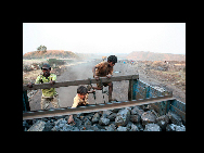 With no other source of income the Locals of Jharia have taken to stealing and looting the Coal from coal trucks which transport the coal from the coal mines to the storage depots. For India, the Jharia coal fields in Dhanbad, Jharkhand is the source of most of the nation's coal. But for the people who live above an inferno, Jharia is a condemned place. [China Daily/CHIPP Organizing Committee] 