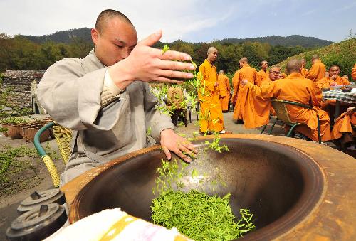 A monk stir-fries the 'zen tea' at a tea garden in Fajing Buddha Temple in Hangzhou, capital of east China's Zhejiang Province, March 25, 2010. 