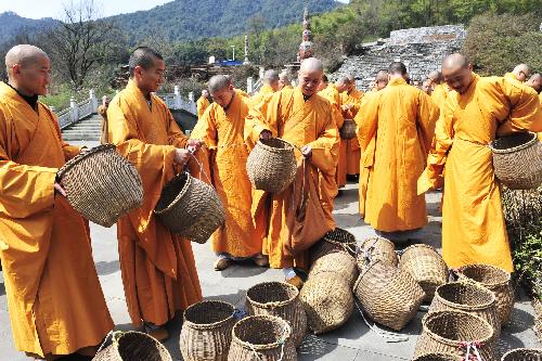 Monks prepare bamboo baskets for tea picking at a tea garden in Fajing Buddha Temple in Hangzhou, capital of east China's Zhejiang Province, March 25, 2010. 