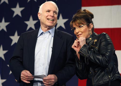 U.S. Senator John McCain (L) and former Alaska governor and vice presidential candidate Sarah Palin acknowledge the crowd during a campaign rally for McCain at the Pima County Fairgrounds in Tucson, Arizona March 26, 2010. McCain, who is seeking a fifth term as U.S. Senator, received Palin's endorsement and will challenge JD Hayworth during the Republican primary in August 2010.