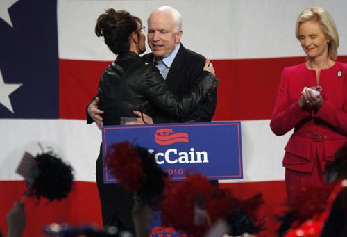 Former Alaska Governor and Vice Presidential candidate Sarah Palin (L) hugs U.S. Senator John McCain (R-AZ) as she introduces him as his wife Cindy McCain looks on during a campaign rally for McCain at the Pima County Fairgrounds in Tucson, Arizona March 26, 2010. 