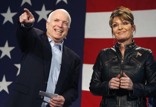 U.S. Senator John McCain (L) and former Alaska governor and vice presidential candidate Sarah Palin acknowledge the crowd during a campaign rally for McCain at the Pima County Fairgrounds in Tucson, Arizona March 26, 2010.