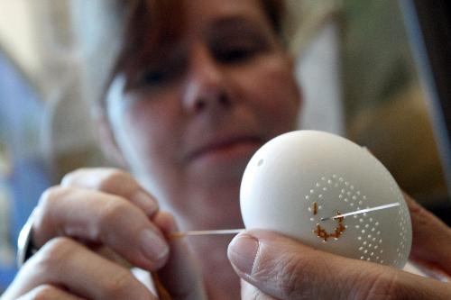 The photo taken on March 26 shows that an artist makes an Easters Egg at an Easter trade fair, which is held in a Museum in Hamburg, Germany.