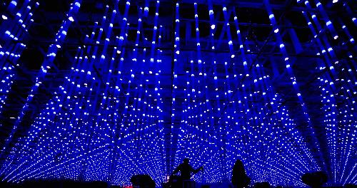 Workers are seen outside the Shanghai Corporate Pavilion on lighting trial at the Expo Park in Shanghai, east China, March 26, 2010. The Expo Park will be put into trial operation in the end of April.