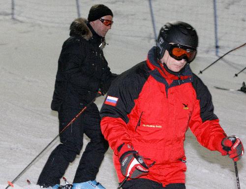 Russian President Dmitry Medvedev (L) and Prime Minister Vladimir Putin ski at Krasnaya Polyana ski resort near Sochi March 26, 2010.