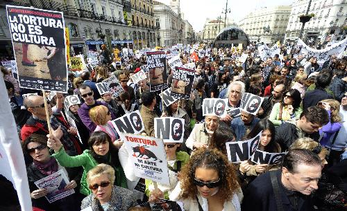 Protestors holding placards reading, &apos;Torture is not Art or Culture&apos; march during a demonstration of several thousand people calling for the abolition of bullfighting in center of Madrid, March 28, 2010. [Xinhua]