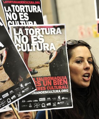 A female protestor holding placards reading, &apos;Torture is not Art or Culture&apos; march during a demonstration of several thousand people calling for the abolition of bullfighting in center of Madrid, March 28, 2010. [Xinhua]