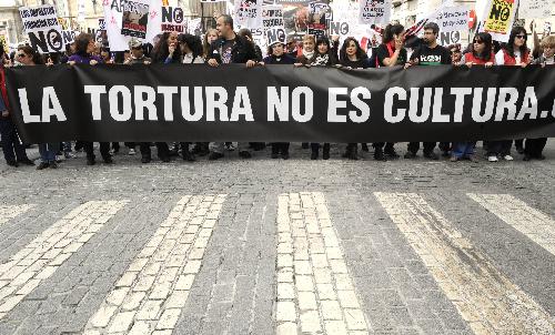 Protestors holding placards reading, &apos;Torture is not Art or Culture&apos; during a demonstration of several thousand people calling for the abolition of bullfighting in center of Madrid, March 28, 2010. [Xinhua]