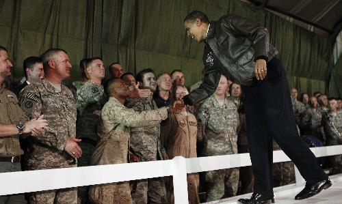 U.S. President Barack Obama meets with troops at Bagram Air Base in Kabul, March 28, 2010. Obama arrived unannounced in Afghanistan on Sunday, his first visit to the war zone that could define his presidency since his election as U.S. commander-in-chief. Air Force One landed in darkness at Bagram airfield north of the Afghan capital, and Obama was whisked by helicopter to Hamid Karzai&apos;s palace in Kabul, where he was greeted by the Afghan president and a band playing the U.S. national anthem. [Xinhua]