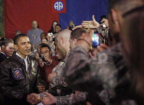 U.S. President Barack Obama meets with troops at Bagram Air Base in Kabul, March 28, 2010. Obama arrived unannounced in Afghanistan on Sunday, his first visit to the war zone that could define his presidency since his election as U.S. commander-in-chief. Air Force One landed in darkness at Bagram airfield north of the Afghan capital, and Obama was whisked by helicopter to Hamid Karzai&apos;s palace in Kabul, where he was greeted by the Afghan president and a band playing the U.S. national anthem. [Xinhua]