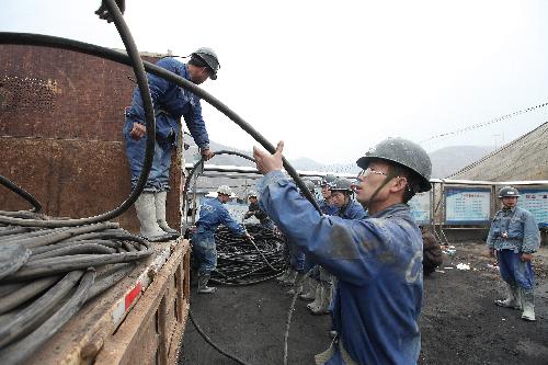 Rescuers work at the site of a flooding accident of Wangjialing Coal Mine, sitting astride Xiangning County of Linfen City and Hejin City of Yuncheng City, in north China's Shanxi Province, on March 29, 2010. (Xinhua