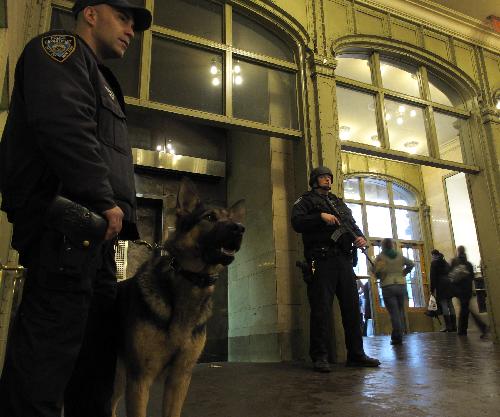Police officers of the New York Police Department (NYPD) stand guard at the Grand Central Station in New York, the United States, March 29, 2010. New York City stepped up security as a precaution Monday following the suicide bombings in Moscow's subway system, sending more police into rail and subway stations. [Xinhua]