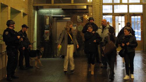 Police officers of the New York Police Department (NYPD) stand guard at the Grand Central Station in New York, the United States, March 29, 2010. New York City stepped up security as a precaution Monday following the suicide bombings in Moscow's subway system, sending more police into rail and subway stations. [Xinhua]