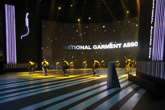 Dancers pose at the beginning of the 6th China National Garment Association Awards at the Century Theater in Beijing on March 28, 2010. 