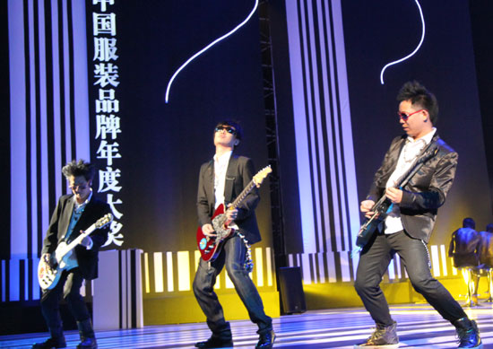 Guitarists perform at 6th China National Garment Association Awards at the Century Theater in Beijing on March 28, 2010.