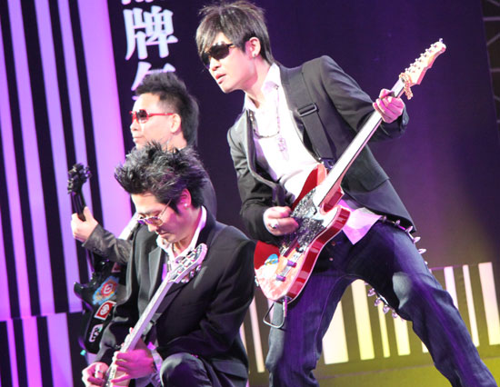 Guitarists perform at 6th China National Garment Association Awards at the Century Theater in Beijing on March 28, 2010. 