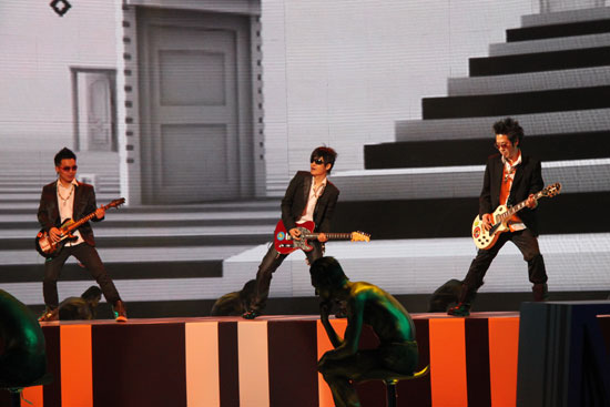 Guitarists perform at 6th China National Garment Association Awards at the Century Theater in Beijing on March 28, 2010. 