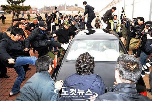 The car of Choi Won-il, captain of the sunken South Korean naval ship Cheonan, is surrounded by family members of the missing marines after he briefed them at the naval port in Pyeongtaek, south of Seoul, South Korea, on Saturday. 