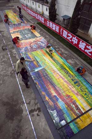 Workers clean a huge mural for the 2010 World Expo in Luoyang, central China's Henan Province, March 30, 2010. The 26-meter-long and 3.2-meter-high mural of Tang Tri-colored pottery for the Henan Pavilion in Expo Park is packed and transported to Shanghai on Monday. Photo: Xinhua