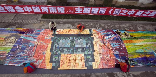 Workers clean a huge mural for the 2010 World Expo in Luoyang, central China's Henan Province, March 30, 2010. The 26-meter-long and 3.2-meter-high mural of Tang Tri-colored pottery for the Henan Pavilion in Expo Park will be packed and transported to Shanghai.