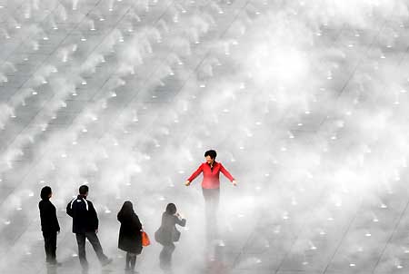 Visitors take pictures at the celebration square in Expo Park in Shanghai, March 30, 2010. [Xinhua]