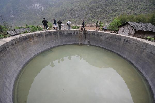 Villagers flood water to a pool in Tian'e county of south China's Guangxi Zhuang Autonomous Region, on March 31, 2010. More than three million residents are suffering from water shortage in Guangxi which was hit by the worst drought in a century. [Xinhua]