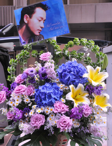 Bouquets and photographs of the late Hong Kong singer-actor Leslie Cheung are seen in front of the Mandarin Oriental Hotel in Hong Kong in this series of photos taken on March 31, 2010. 