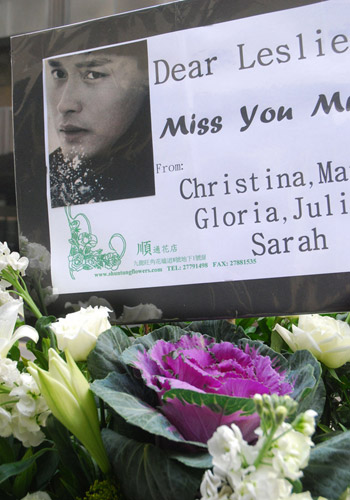 Bouquets and photographs of the late Hong Kong singer-actor Leslie Cheung are seen in front of the Mandarin Oriental Hotel in Hong Kong in this series of photos taken on March 31, 2010. 